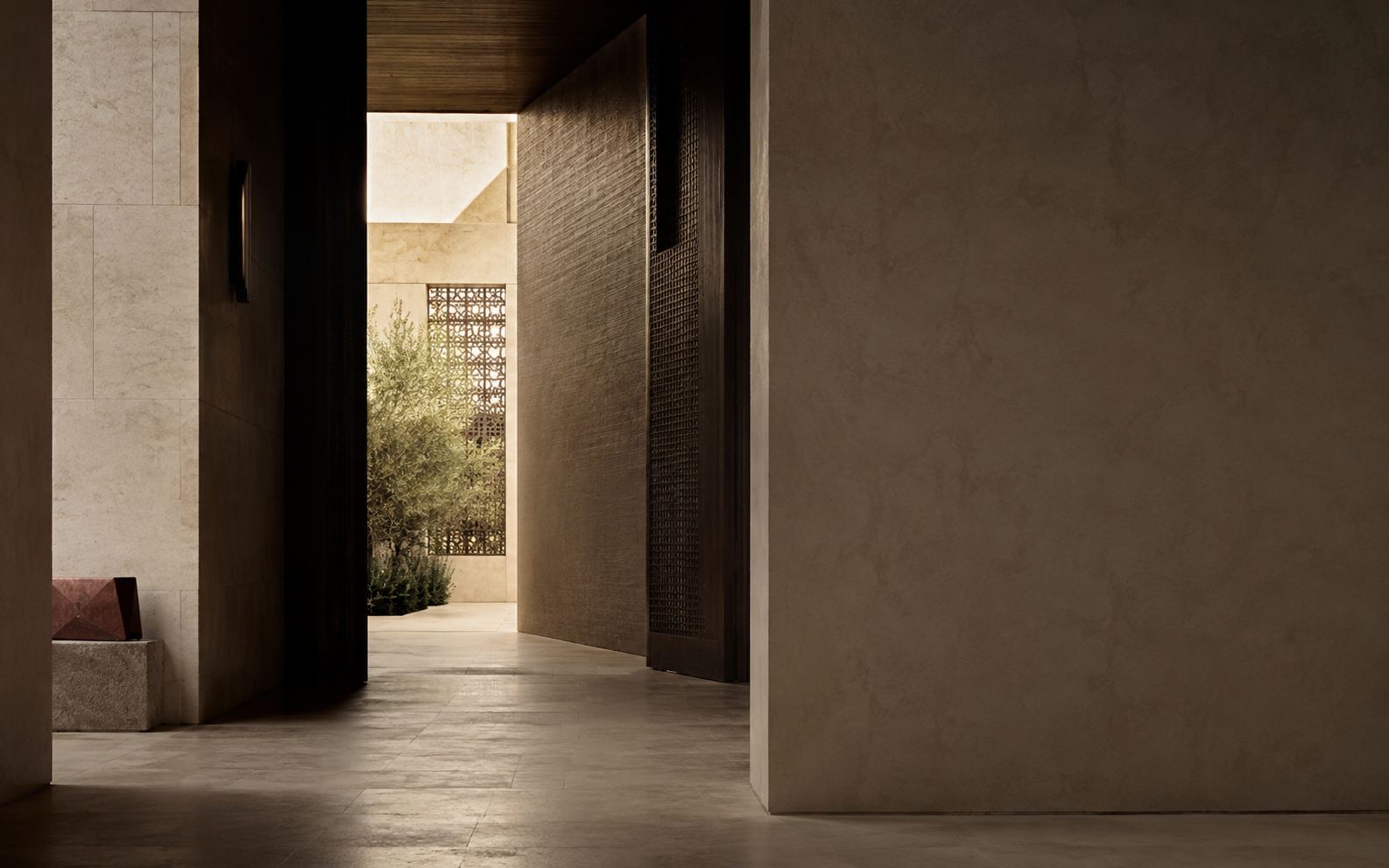 ممر حجري ينفتح نحو فناء مضاء — a stone passage opening toward light